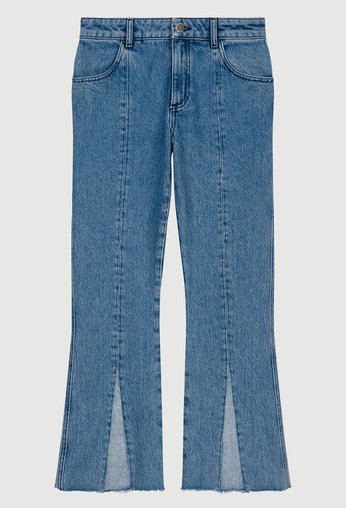 Flared blue jeans with frayed ends