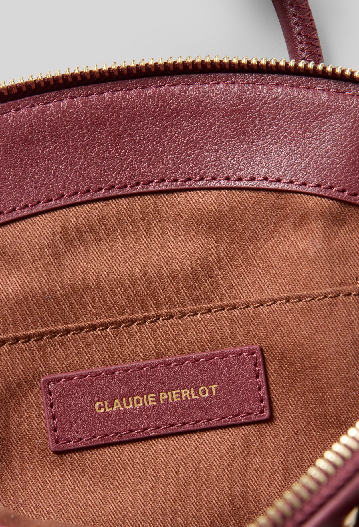 Glattledertasche mit Goldringen
